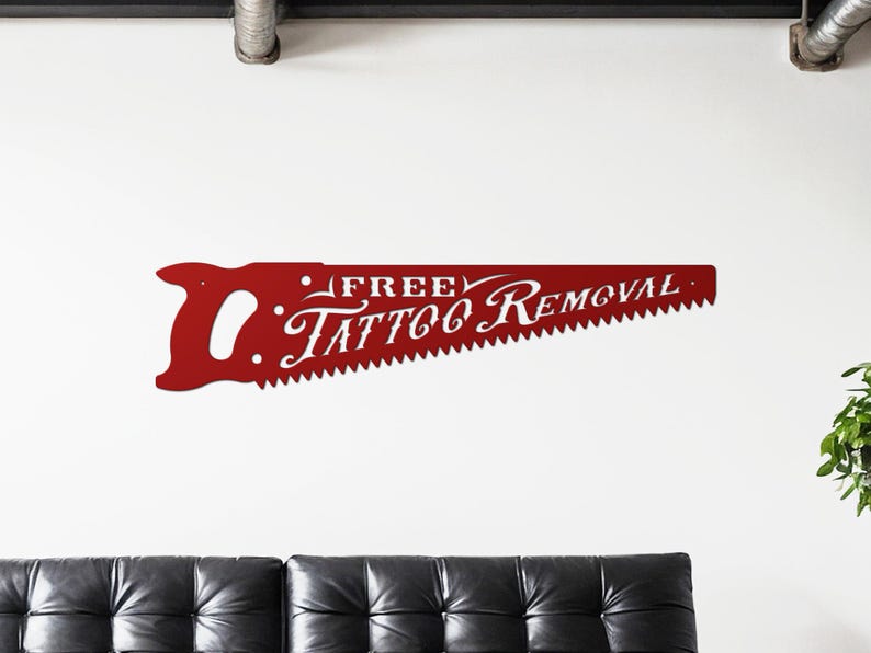 Sign shaped like a handsaw with the words Free Tattoo Removal cut out of it. Powder coated in a gloss red powder coat.