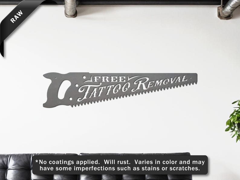 Sign shaped like a handsaw with the words Free Tattoo Removal cut out of it. The sign is raw steel.