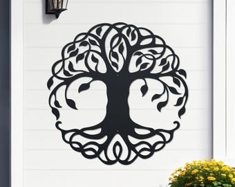 May include: Black metal tree of life wall art. The design features a detailed tree silhouette with leaves and intertwined branches, set against a white background. The artwork is mounted on a white wall, with a black outdoor light fixture above.