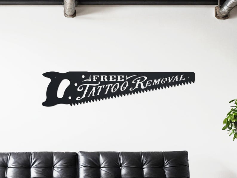 Sign shaped like a handsaw with the words Free Tattoo Removal cut out of it. Powder coated in a matte black powder coat.