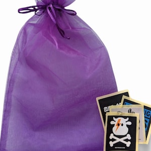 a purple bag filled with stickers and a bag of stickers