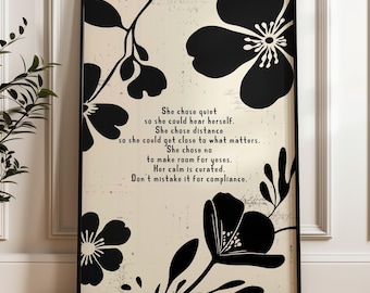 May include: Black framed art print featuring black floral silhouettes on a cream background. The print includes the text: "She chose quiet...Her calm is curated. Don't mistake it for compliance."