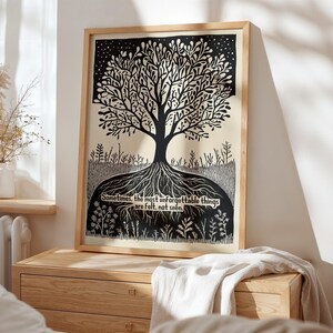 May include: A framed black and white art print featuring a stylized tree with roots and branches. The artwork includes the text: "Sometimes, the most unforgettable things are felt, not seen." The print is displayed on a wooden dresser.