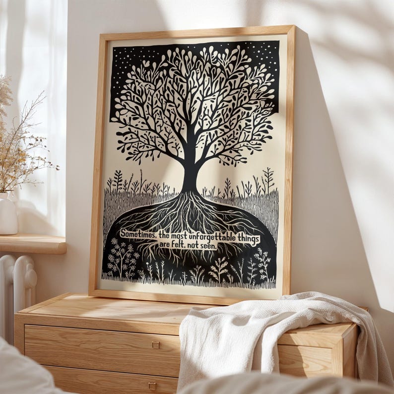 May include: A framed black and white art print featuring a stylized tree with roots and branches. The artwork includes the text: "Sometimes, the most unforgettable things are felt, not seen." The print is displayed on a wooden dresser.