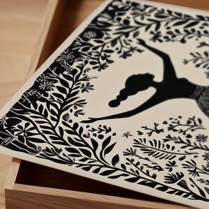 May include: A decorative tray featuring a black silhouette of a dancing figure surrounded by detailed black floral and leaf patterns on a cream background. The tray is set inside a wooden box.