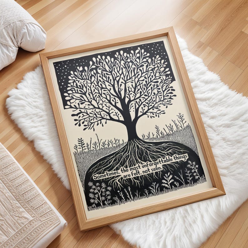 May include: Framed art print featuring a black and white tree illustration with intricate details. The artwork includes a quote: "Sometimes, the most unforgettable things are felt, not seen." The print is set in a natural wood frame.