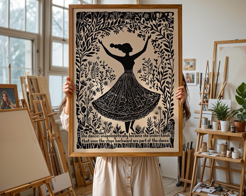 May include: A framed black and white art print featuring a silhouette of a dancing figure in a floral setting. The print includes the text: "She dances unapologetically because she understands that even the steps backward are part of the dance."