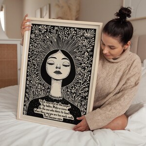 May include: Black and white illustration of a woman with closed eyes surrounded by flowers. The text reads: "Track some mud on the carpet. Flip tables. Make a scene. Be the one who dares to lead. When they say you are too much, smile. Then become more."