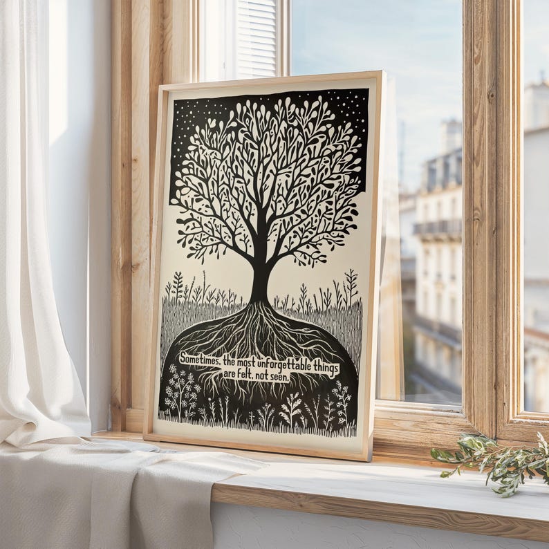 May include: Black and white art print of a tree with roots and branches, set against a starry sky. The print includes the quote: "Sometimes, the most unforgettable things are felt, not seen." The artwork is framed in a light wood frame.