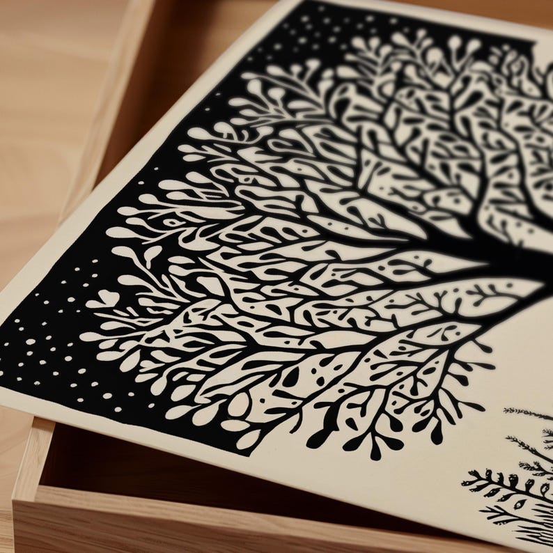 May include: A black and white art print featuring a stylized tree design. The artwork has a detailed, intricate pattern of branches and leaves against a cream-colored background. The print is displayed in a wooden box.