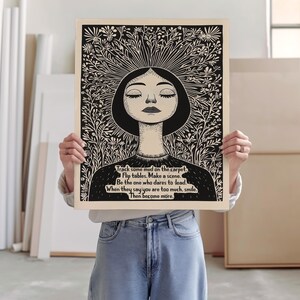 May include: Black and white illustration of a woman with her eyes closed, surrounded by flowers. The text reads: "Track some mud on the carpet. Flip tables. Make a scene. Be the one who dares to lead. When they say you are too much, smile. Then become more."