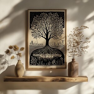 May include: A framed black and white art print of a tree with roots and branches. The print includes the text, "Sometimes, the most unforgettable things are felt, not seen." The print is displayed on a wooden shelf with vases.