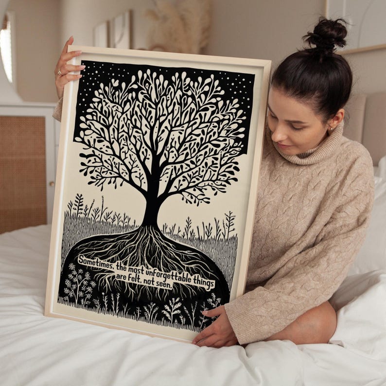 May include: A framed black and white art print featuring a stylized tree with intricate branches and roots. The artwork includes the text: "Sometimes, the most unforgettable things are felt, not seen."