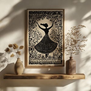 May include: Black and white framed art print featuring a silhouette of a dancing figure surrounded by floral elements. The print includes the quote: "She dances unapologetically because she understands that even the steps backward are part of the dance."
