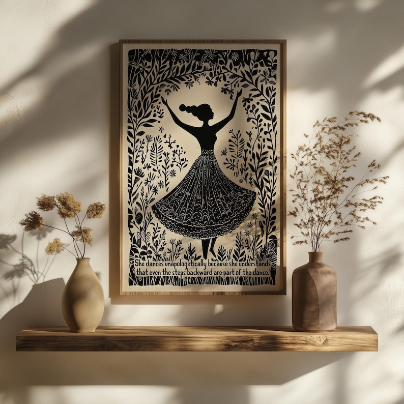 May include: Black and white framed art print featuring a silhouette of a dancing figure surrounded by floral elements. The print includes the quote: "She dances unapologetically because she understands that even the steps backward are part of the dance."