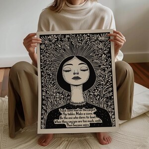 May include: Black and white illustration of a woman with her eyes closed, surrounded by flowers. The text reads: "Track some mud on the carpet. Flip tables. Make a scene. Be the one who dares to lead. When they say you are too much, smile. Then become more."