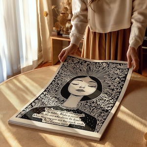 May include: Black and white illustration of a woman with her eyes closed, surrounded by flowers. The text reads: "Track some mud on the carpet. Flip tables. Make a scene. Be the one who dares to load. When they say you are too much, smile. Then become more."