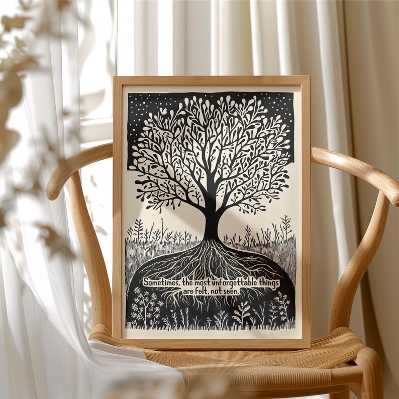 May include: A framed black and white art print featuring a tree design. The tree has a detailed root system and branches, with the text "Sometimes, the most unforgettable things are felt, not seen." The artwork is displayed on a wooden chair.