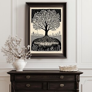 May include: Black and white framed art print featuring a tree with intricate branches and roots. The artwork includes the text: "Sometimes, the most unforgettable things are felt, not seen." The print is displayed on a wall above a dark wooden dresser.