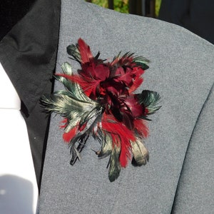 Brilliant black and red large feather boutonniere