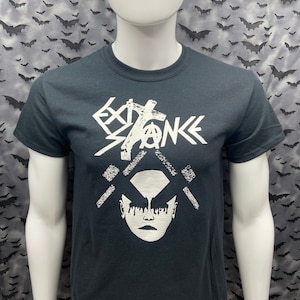 May include: Black t-shirt with a white graphic design. The design features a stylized face with dripping makeup and the text "EXTINCTION" with an anarchy symbol.