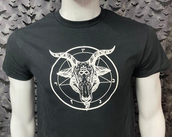 May include: Black t-shirt with a white graphic of a goat's head inside a circle with symbols.