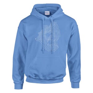 May include: A pale blue hoodie featuring a white topographical map design. The hoodie has a drawstring hood and a front pocket. The brand name "Gildan" is visible on the inside of the hood. This sweatshirt is ideal for anyone who loves maps or the outdoors.