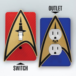 May include: Two Star Trek themed wall plates, one for a light switch and one for an outlet. The switch plate is red with a gold Starfleet insignia. The outlet plate is blue with a gold Starfleet insignia.