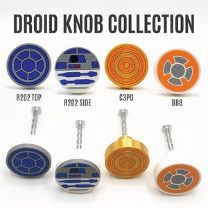 May include: A Droid Knob Collection featuring four circular cabinet knobs with designs inspired by R2D2, C3PO, and BB8. The set includes top and side views of the R2D2 knob, a gold C3PO knob, and an orange and white BB8 knob, each with a metal screw.