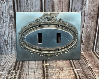 Tapa de interruptor de luz metálica con forma de águila, estilo vintage de los años 70.