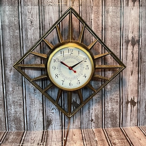 Vintage Mid Century Atomic Starburst wandklok elektrisch goudkleurig van de United Clock Company