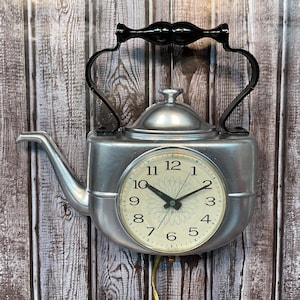 May include: A white ceramic mug with a black handle and the text "But First, Coffee" in a handwritten style. The mug is on a white surface. The mug is 4 inches tall.