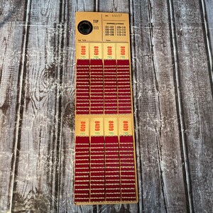 May include: Vintage tip ticket with the number 111 and the text "TIP". The ticket has a series of red and white perforated sections, each labeled with the number "8409". The top section has the text "CONSOLATIONS".