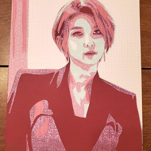 May include: A red paper cutout of a person with short, pink hair wearing a red jacket. The person's face is partially obscured by a white paper cutout of a face mask.