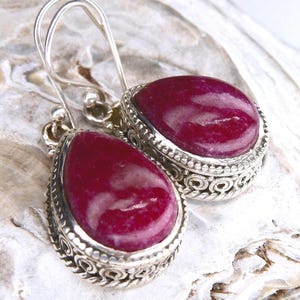 May include: A set of three ceramic mugs with a speckled, matte finish in cream, light grey, and dark grey. Each mug has a simple, minimalist design and a rounded handle.