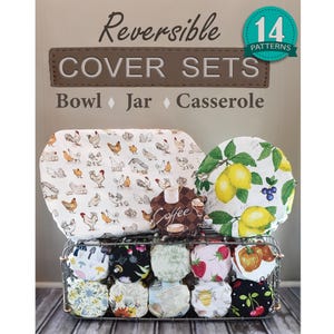 May include: A collection of reversible fabric bowl, jar, and casserole cover sets featuring 14 patterns including chickens, lemons, strawberries, and coffee themes. The covers are displayed in a wire basket with text reading Reversible COVER SETS.