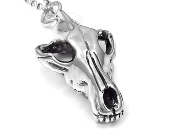 May include: A silver pendant necklace featuring a detailed wolf skull design. The pendant is attached to a silver chain.
