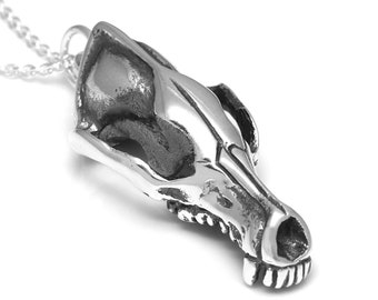 May include: A silver necklace with a detailed skull pendant. The pendant is a realistic depiction of an animal skull, with visible teeth and bone structure.