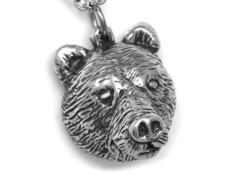 May include: Silver bear head pendant necklace. The bear's head is detailed with fur and has a realistic expression.