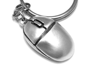 May include: A silver computer mouse keychain with a key ring attached.