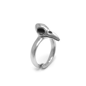May include: A silver-colored ring featuring a bird skull design. The ring has a smooth, polished finish and a curved band that wraps around the finger. The skull has detailed eye sockets and a pointed beak, creating a unique and gothic aesthetic.