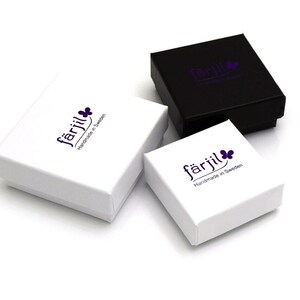 May include: Three small square boxes with the logo "f&auml;rjil Handmade in Sweden" printed on the top. The boxes are white with a black box in the background.