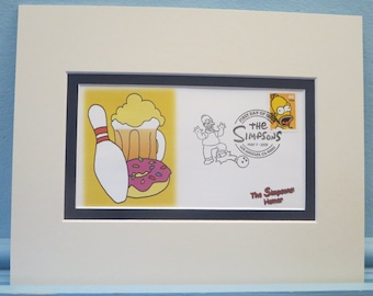 Hedrar Simpsons TV-serien och första dagens omslag för Homer Simpson-frimärket