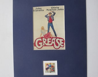 John Travolta y Olivia Newton-John en "Grease" y el sello del Rock and Roll