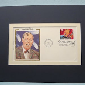 May include: A framed first-day cover featuring a 29-cent stamp with a portrait of Bill Haley, a musician known for his rock and roll music. The cover also features a commemorative stamp for the 50th anniversary of rock and roll. The text on the cover reads "Legends of American Music" and "Celebrations".