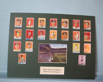 May include: A framed display of 1958 New York Yankees baseball cards, featuring players like Mickey Mantle, Yogi Berra, and Whitey Ford. The display also includes a photo of Yankee Stadium.