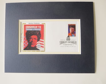 May include: A framed first day of issue stamp commemorating Shirley Chisholm, the first African American woman elected to Congress. The stamp features a portrait of Chisholm and the text "Shirley Chisholm '72 Unbought & Unbossed".