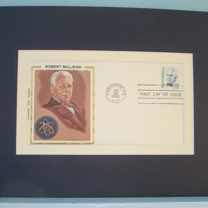 May include: A first day of issue envelope featuring a portrait of Robert Millikan, an American physicist. The envelope is cream colored with a blue stamp depicting Millikan and the text "First Day of Issue". The envelope also has a red postmark from Pasadena, California, dated January 26, 1982.