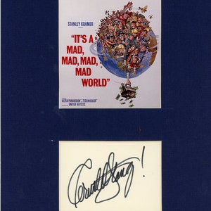 May include: A vintage movie poster for the film "It's a Mad, Mad, Mad, Mad World" directed by Stanley Kramer. The poster features a colorful illustration of a globe with people clinging to it. The poster is signed by the director, Stanley Kramer.