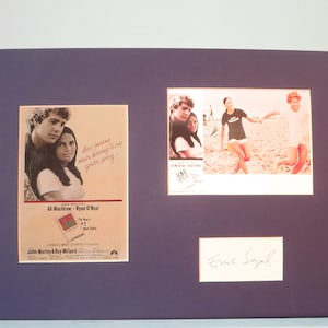 以下が含まれることがあります： アリ・マッグローとライアン・オニールをフィーチャーした映画「愛と別れ」の額装された映画ポスター。ポスターには映画からの引用「愛とは、ごめんなさいと言わなくても済むこと」が書かれている。ポスターは、映画の原作小説の著者であるエリック・シーガルによってサインされている。